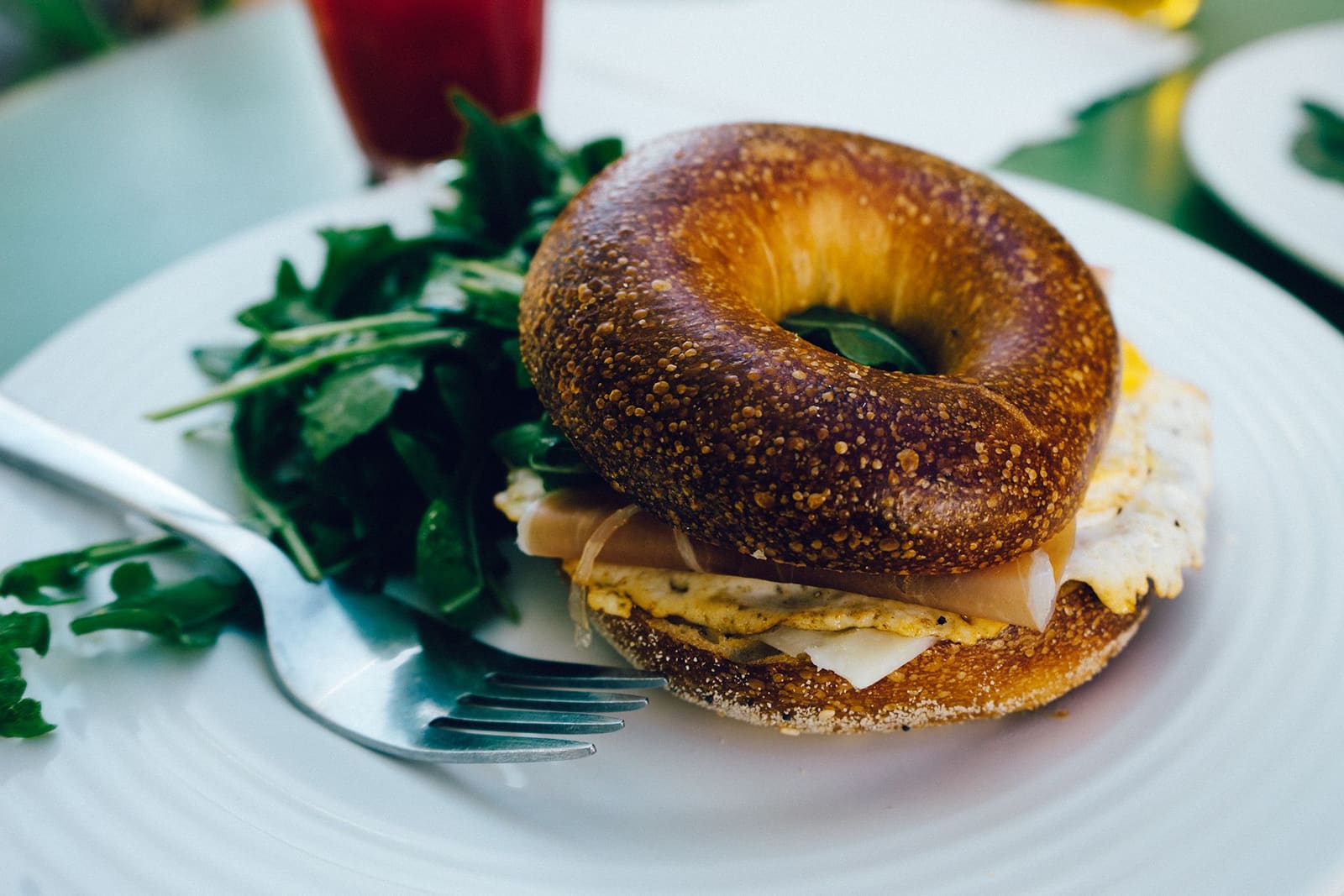 Bagel garni servi avec de la salade verte